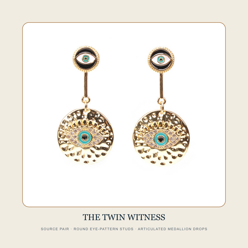 Front source pair of The Twin Witness round eye-pattern medallion drop earrings