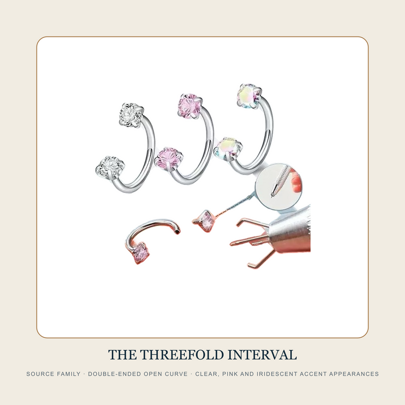 The Threefold Interval source family showing clear pink and iridescent double-ended open curved rings