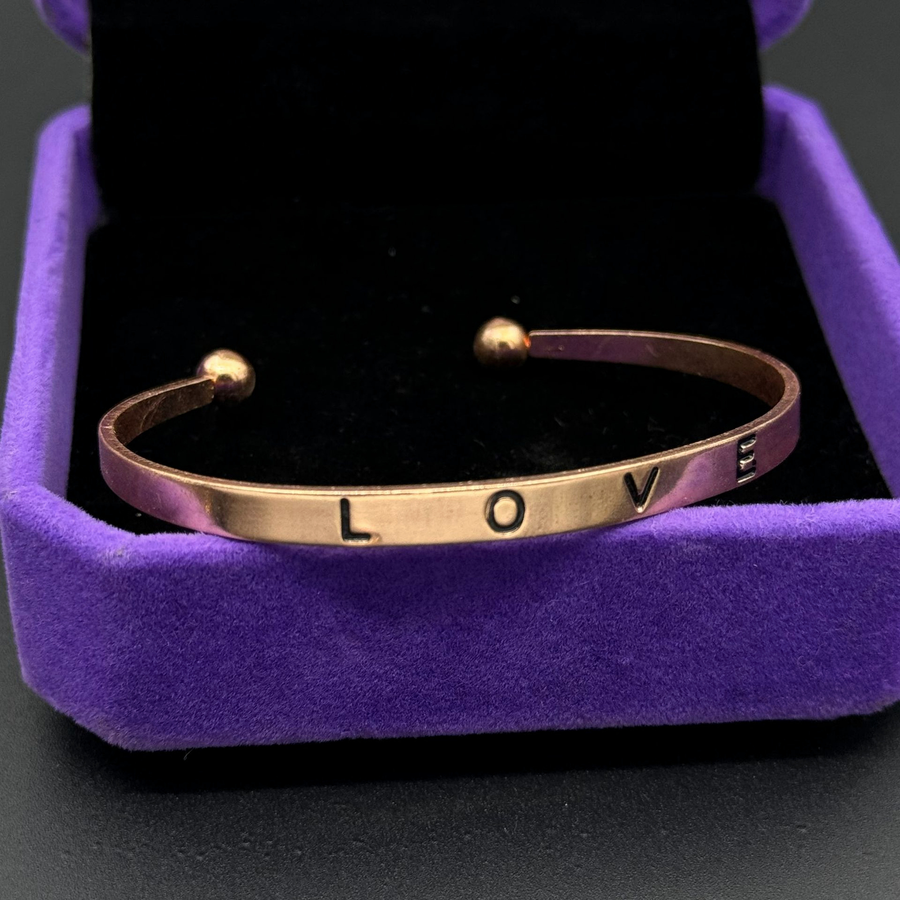 The Loveband Rose Gold cuff shown in a real velvet jewelry box