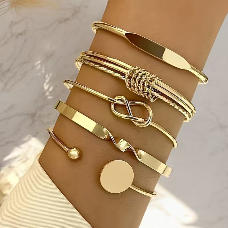Source-worn view of The Six Kept Lines preselected gold-tone six-piece mixed bangle set