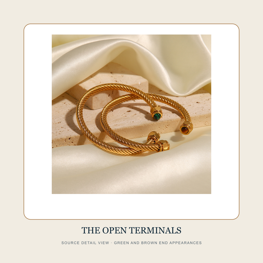 Detail source view of the twisted cable bands and green and brown terminal appearances on The Four Earths cuffs