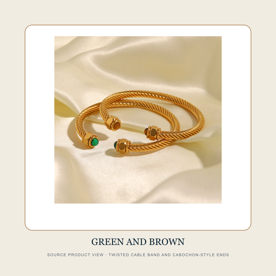 Source product view of The Four Earths gold-tone open cuffs with green and brown cabochon-style ends