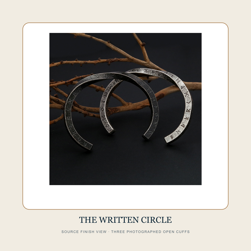 Source finish view of The Written Circle engraved open cuffs in three photographed steel-to-black appearances