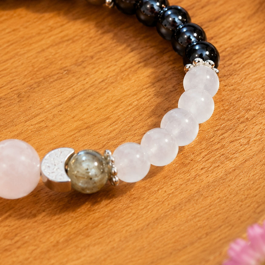 Close detail of The Two Tides pale beads, green-gray accent, and crescent spacer
