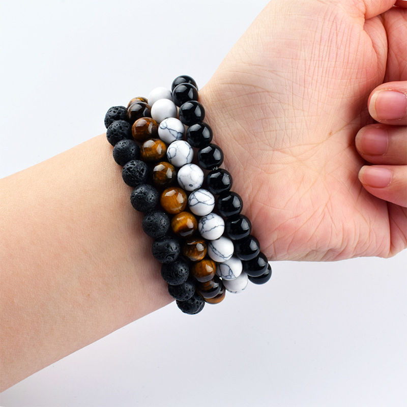 Worn comparison of three active bracelet surfaces plus one white supplier sample that is not sold
