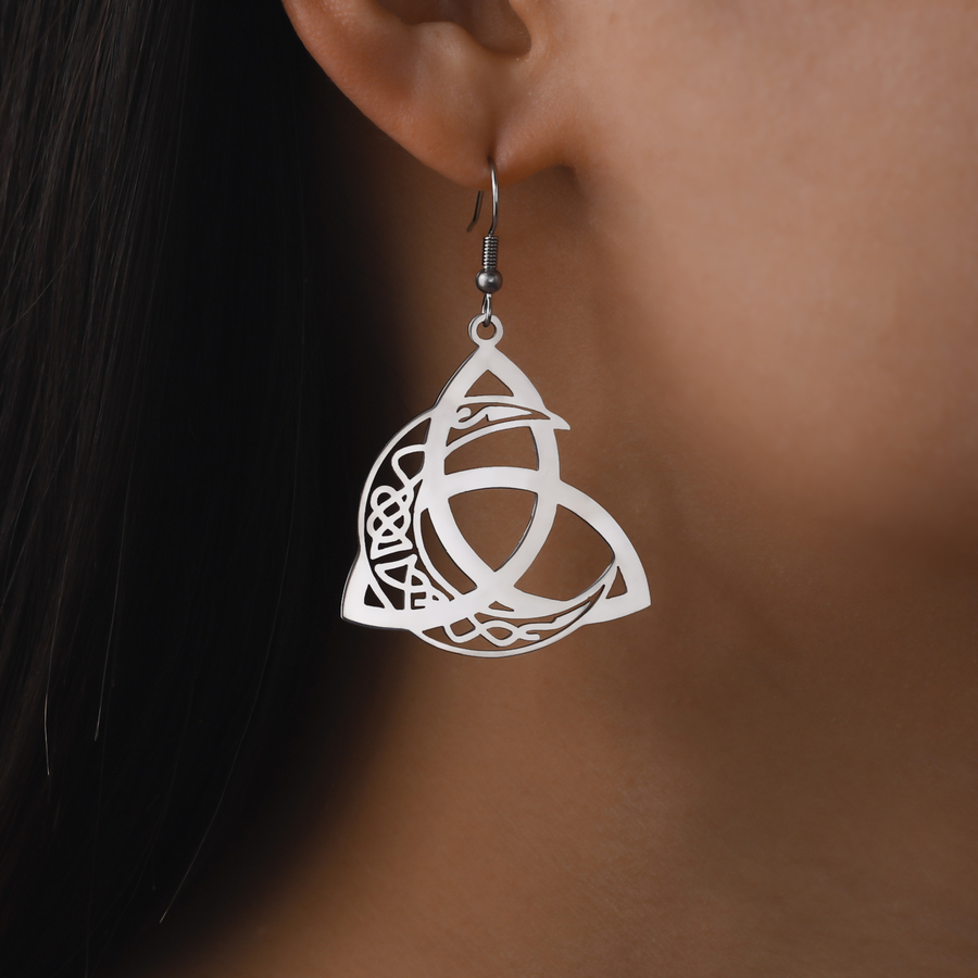 Worn scale view of The Moonknot steel-tone openwork drop earring