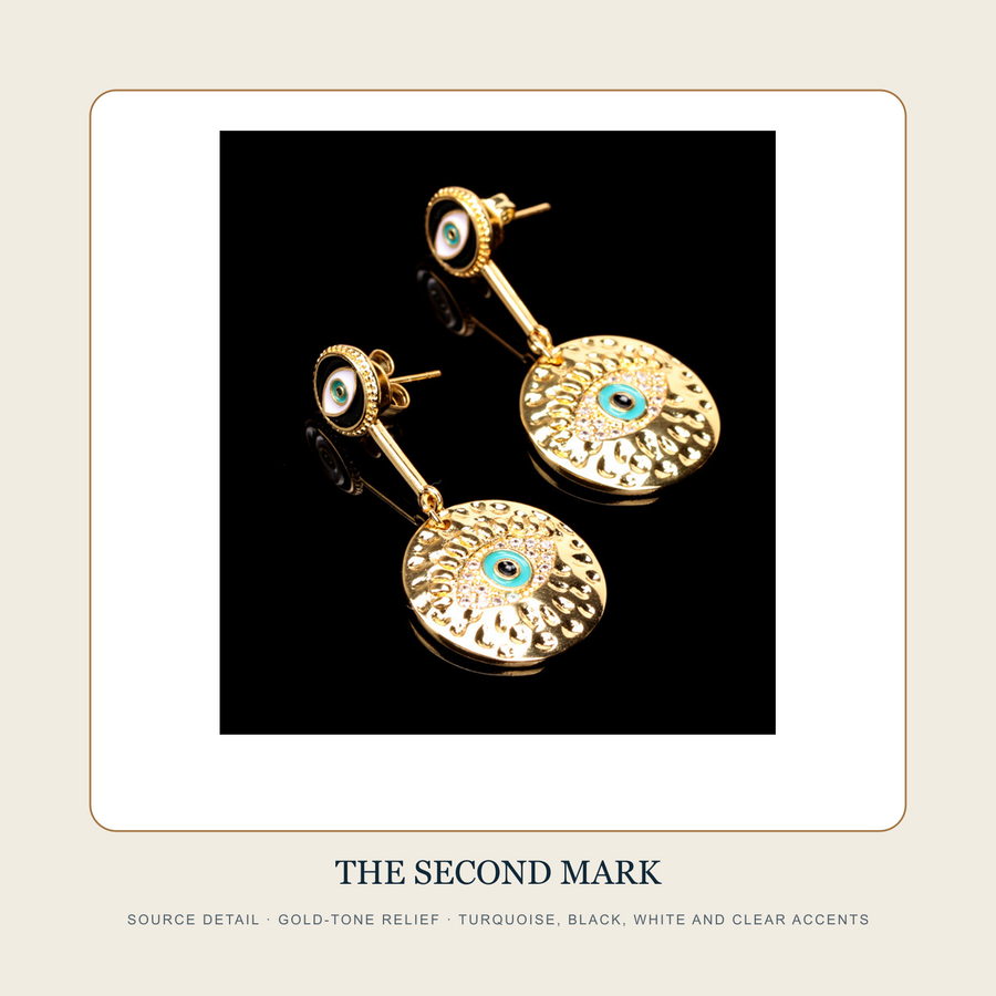 Source detail of The Twin Witness gold-tone relief and turquoise black white accents