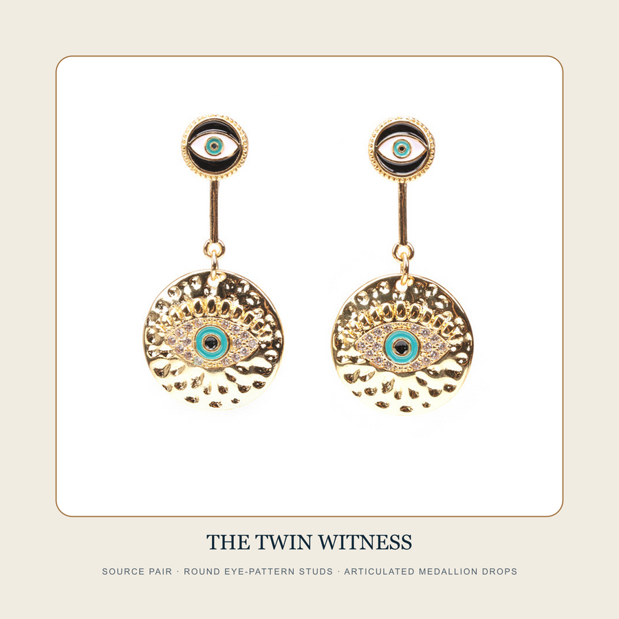 Front source pair of The Twin Witness round eye-pattern medallion drop earrings