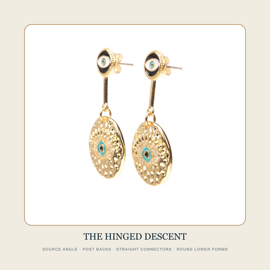 Angled source view of The Twin Witness post earrings and articulated round drops
