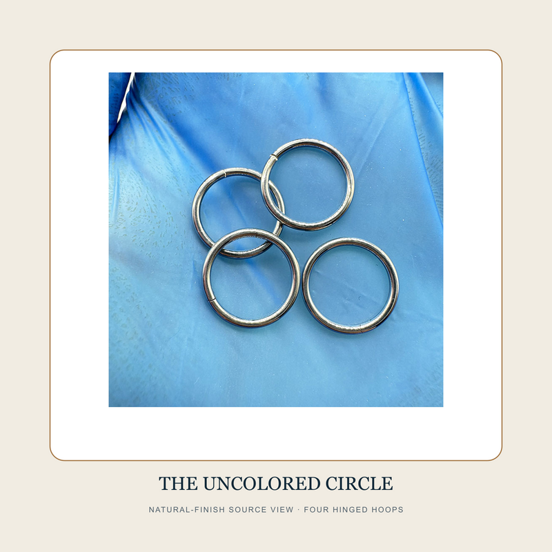 Natural-finish source view of four The Uncolored Circle plain hinged segment hoops