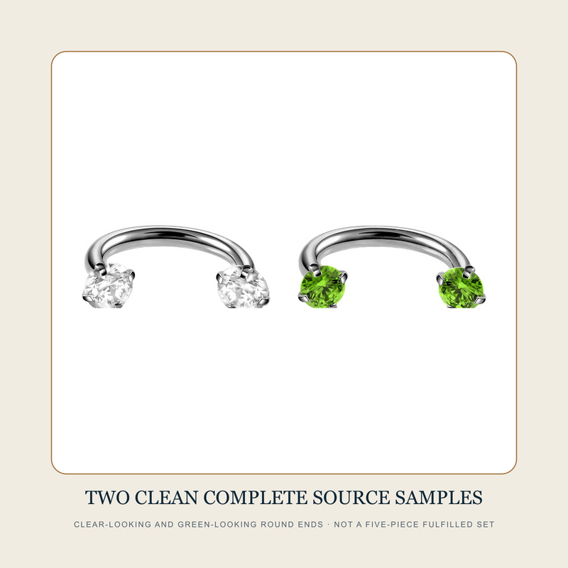 Two clean complete steel-tone open curved-bar source assemblies with clear-looking and green-looking round accent ends