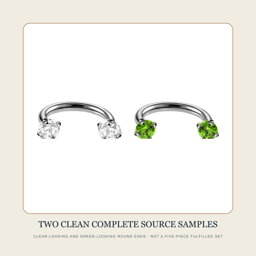 Two clean complete steel-tone open curved-bar source assemblies with clear-looking and green-looking round accent ends