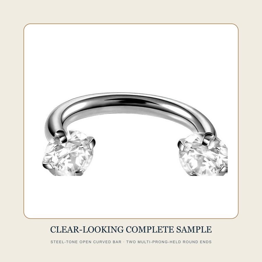 Complete steel-tone open curved-bar source sample with two clear-looking multi-prong-held round ends