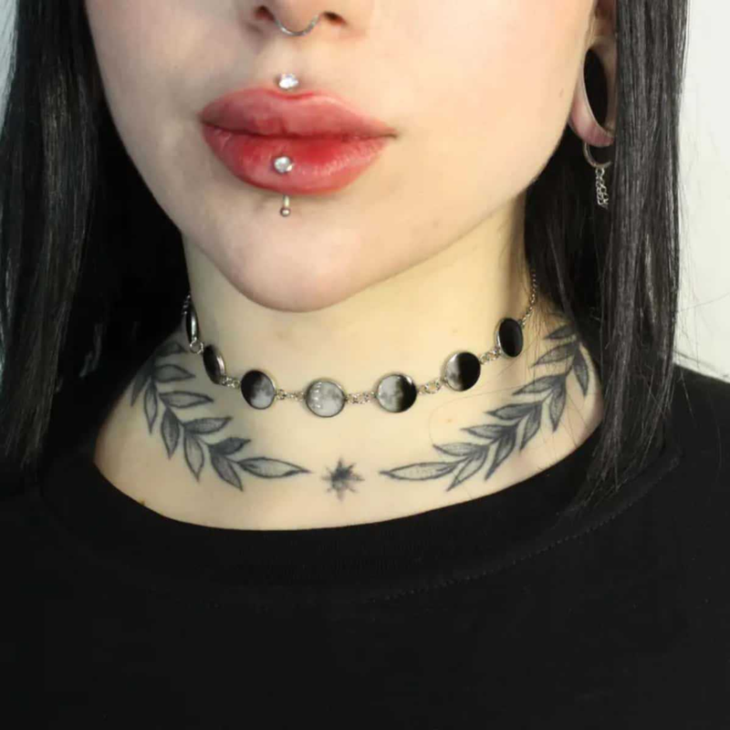 Source-worn front view of The Seven Faces seven-panel moon-image choker necklace