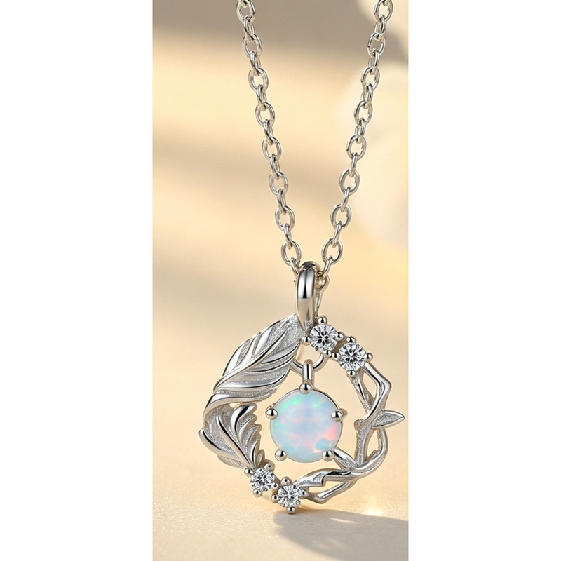 Front source view of The Returning Wing silver-tone leaf-and-bird wreath pendant necklace
