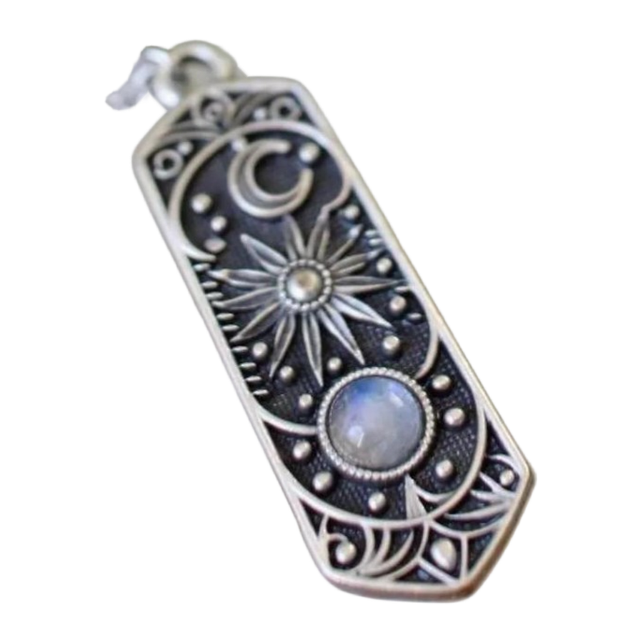 Macro detail of crescent, radiant sun, engraving, and pale cabochon