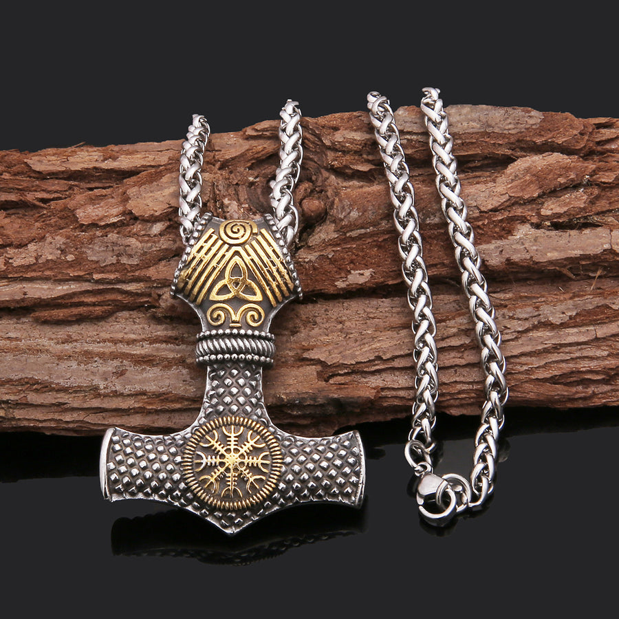 Two-tone gold Stormhammer pendant and woven chain on wood