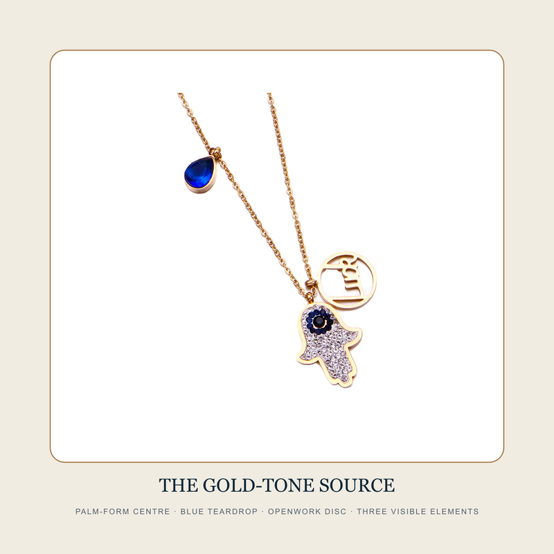 The Three Collected Signs gold-tone multi-charm necklace source view with palm form, blue drop and openwork disc