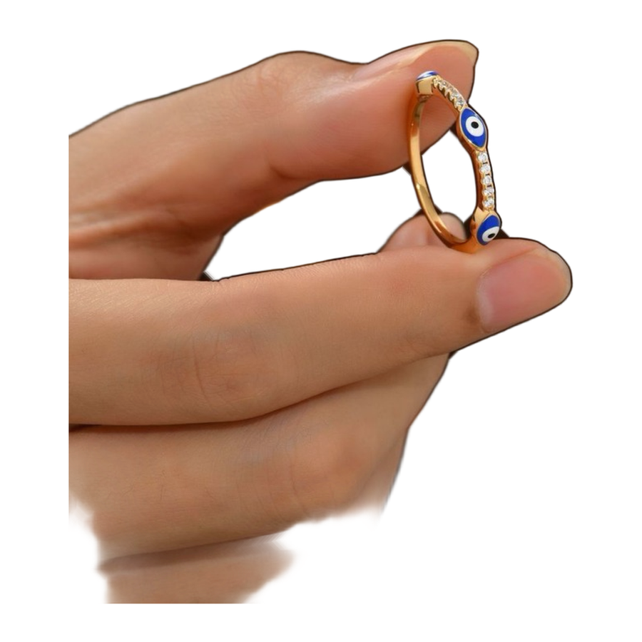 The Quiet Eye slim ring held between fingers for scale