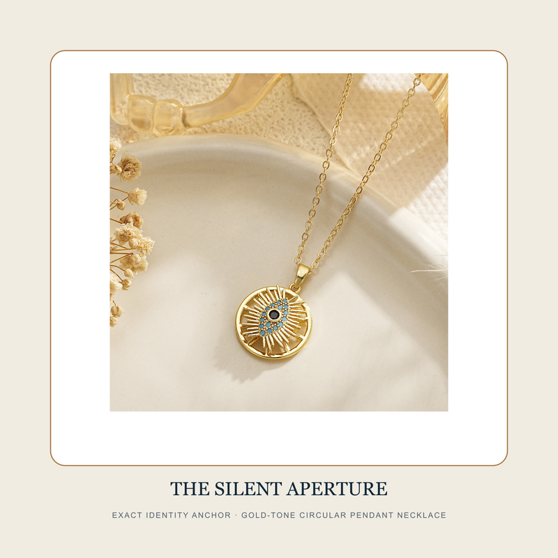 The Silent Aperture exact gold-tone circular radiating eye-motif pendant necklace from the retained identity anchor