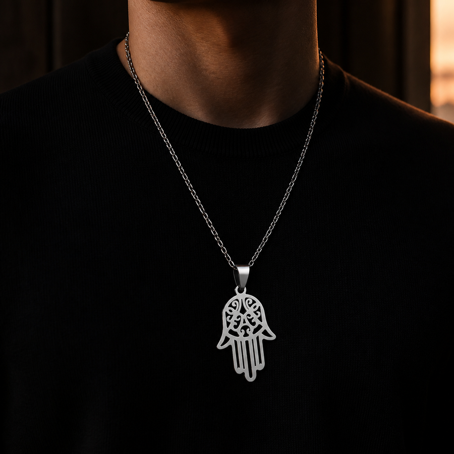 The Open Hand silver necklace worn over a black knit top
